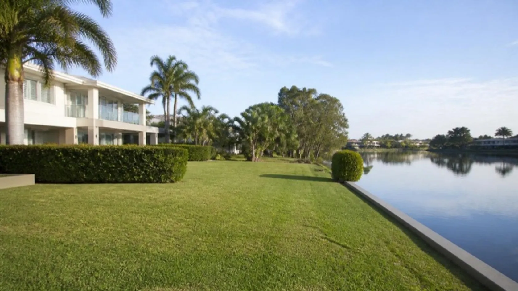 Riverfront home with a broad mown lawn